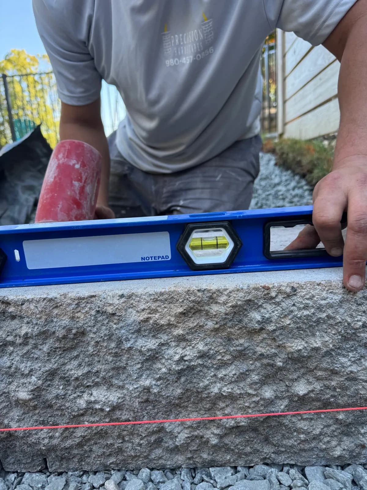 Leveling each course of retaining wall block